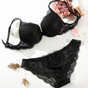 Flat lay of black floral lace lingerie set with push-up bra and matching panties