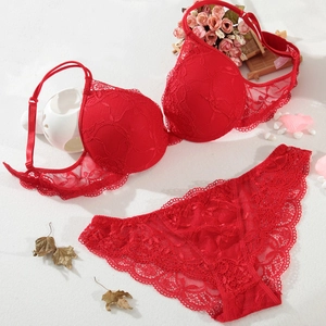 Detailed flat lay of a red lace lingerie set with floral embroidery and mesh details