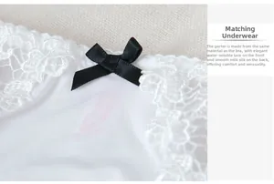 Detailed macro view of white water-soluble lace panties with black satin bow accent