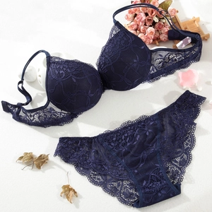 Detailed flat lay of dark blue floral lace lingerie set with elegant flower decor