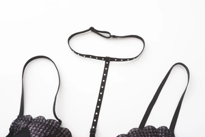 Detail of black lace bra featuring purple metallic thread and sparkling rhinestones