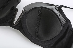 Detail view of black mesh lace bra showing breathable padding and zigzag stitching