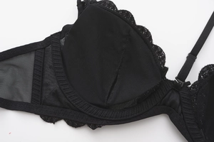 Detail shot of black lace bra cup showing breathable mesh and inner padding structure