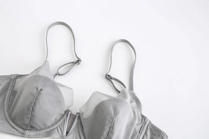 Detail view of grey sheer mesh bra featuring soft underwire and adjustable straps