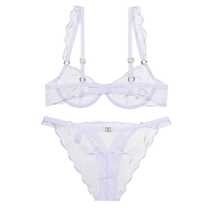 Detailed close-up of white floral lace lingerie set with elegant gold metal ring accents