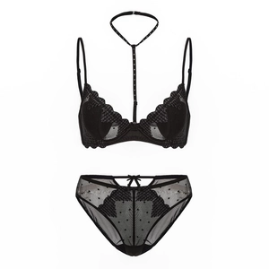 Detail view of black lace lingerie set with halter neck collar and mesh bow details