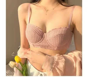 Detailed macro shot of pink waffle texture fabric and underwire on a French demi bra