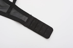 Detail showing four-row back closure and breathable mesh side wings of the black bra