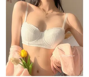 Detail of white waffle texture bra with delicate lace trim and adjustable thin straps
