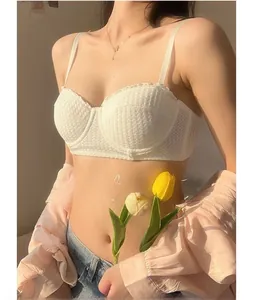 Close-up of white lace bra with fine mesh texture and thin straps for a stylish French look