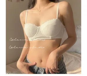 Detail of white lace mesh half-cup bra with delicate texture and thin straps