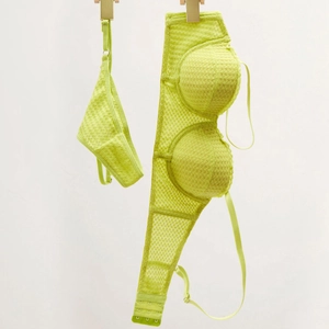 Detail view of lime green lace lingerie set with mesh texture and underwire bra