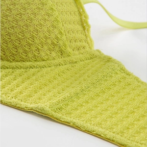 Detailed macro view of the light green lace crochet texture and diamond knit mesh