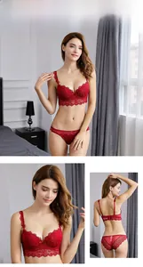 Close-up of red lace push-up bra with delicate bow details and scalloped floral trim