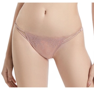 Detailed view of floral lace embroidery and side strap design on nude pink panties