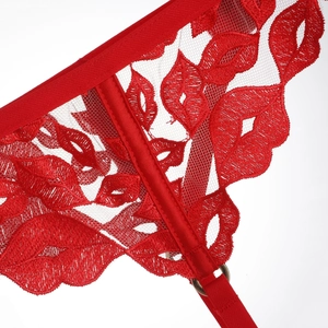 Détail macro du tissu en maille rouge avec broderie rouge à lèvres et anneau en métal