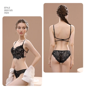 Detailed view of French lace bra featuring floral eyelash patterns and crisscross back straps