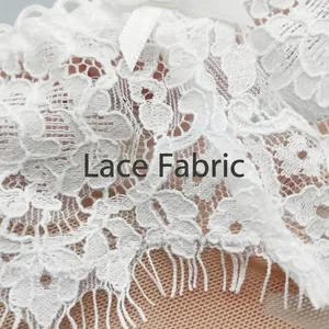 White French eyelash lace thong with floral mesh pattern and small satin bow detail