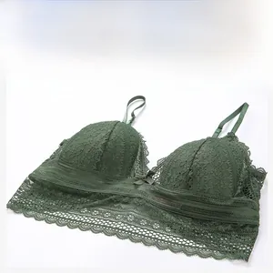 Detailed close-up of dark green lace bra with floral patterns and a small bow detail