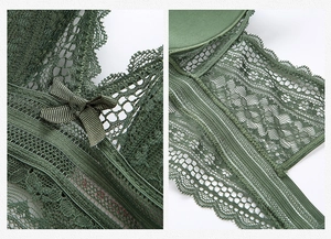 Detail shot of green lace mesh bra showing intricate floral patterns and satin bow decoration