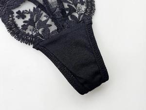Close-up of intricate black floral embroidery on lace panties with premium cotton lining