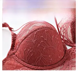 Detailed close-up of dark red floral lace embroidery on a breathable wired mesh bra