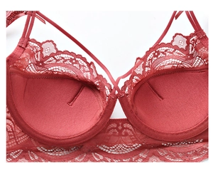 Detailed view of dark red lace bra featuring eyelash trim and internal pad pockets