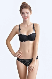 Detail of black lace lingerie set with 1/2 cup bra and delicate vine floral patterns