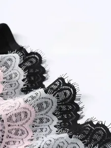 Detail of delicate eyelash lace fabric in black, light blue and pink tones