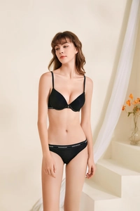 Detail of black lingerie set with contrasting brand logo and fine mesh texture