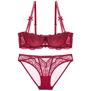 Detail of wine red lace bra set featuring floral embroidery and bow accents on cup straps
