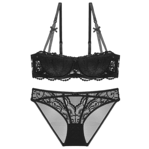 Close-up of intricate vine lace texture and eyelash fringe on the black mesh lingerie set