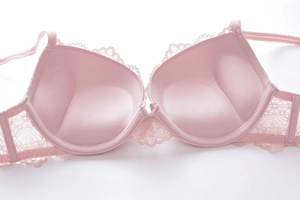 Detailed macro view of push-up bra cups with delicate eyelash lace and thick inner padding