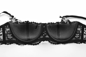 Detailed close-up of the internal cup structure and fine black floral lace of this bra