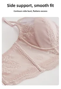 Close-up of pink lace bra side wing featuring supportive boning and breathable mesh fabric