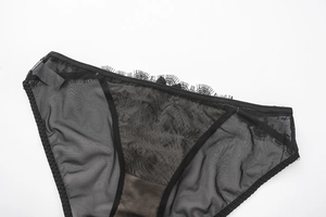 Detail of sheer black mesh panties with eyelash lace trim and refined stitching