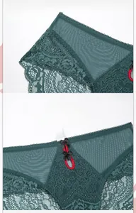 Detail of dark green lace panties featuring sheer mesh texture and floral patterns