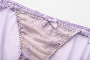 Detail of light purple lace panties with mesh fabric and a small satin bow detail