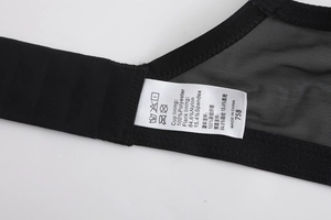 Detail of lace bra interior showing breathable mesh fabric and size label