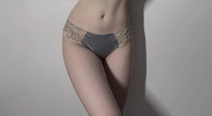 Close-up of elegant grey-blue satin panty featuring detailed black floral embroidery lace