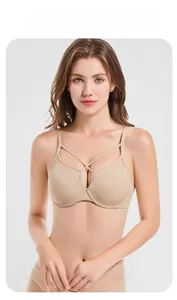 Detailed view of beige seamless bra featuring decorative criss-cross neckline straps