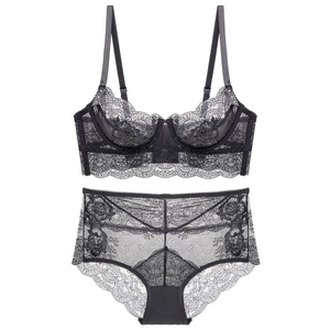 Detailed close-up of semi-transparent black floral lace embroidery on high waist lingerie set