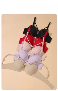 Detail view of multi-color seamless bras with cross-strap design and back hook closure