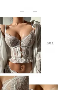 Close-up of white floral lace corset with delicate hollow-out details and ruffled hem