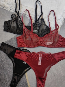 Detailed flat lay of black and wine red sheer mesh lace bras and matching panty sets