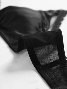 Macro shot of black mesh fabric and delicate lace trim on the wireless triangle bra