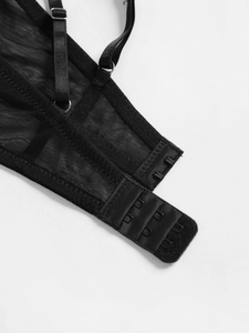 Close-up of black mesh lace bra featuring adjustable straps and three-row hook-eye closure