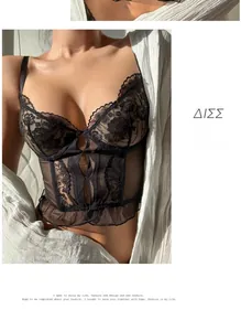 Detail of black lace corset top featuring delicate embroidery and sheer mesh paneling