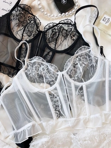 Detail of sheer lace corset lingerie set with floral embroidery and ruffle trim