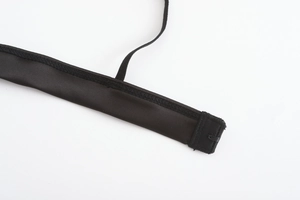 Detailed macro view of black lace lingerie hook fastener and elastic strap adjustments